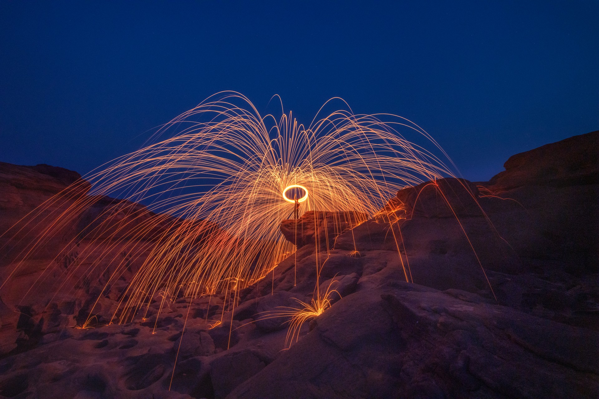 Burning steel wool fireworks, the grand canyon of Thailand (3000 bok) at Sam Pan Bok, Mekong River, Ubon Ratchathani, Thailand.